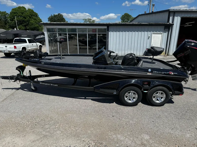 Slide: The Image of 2024 Ranger Z519 Garmin Ranger Cup Equipped boat parked outside a garage. - 1