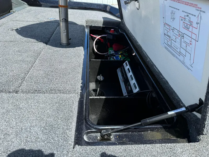 Slide: The Image of 2024 Ranger Z519 Garmin Ranger Cup Equipped boat storage compartment with electronic components. - 12
