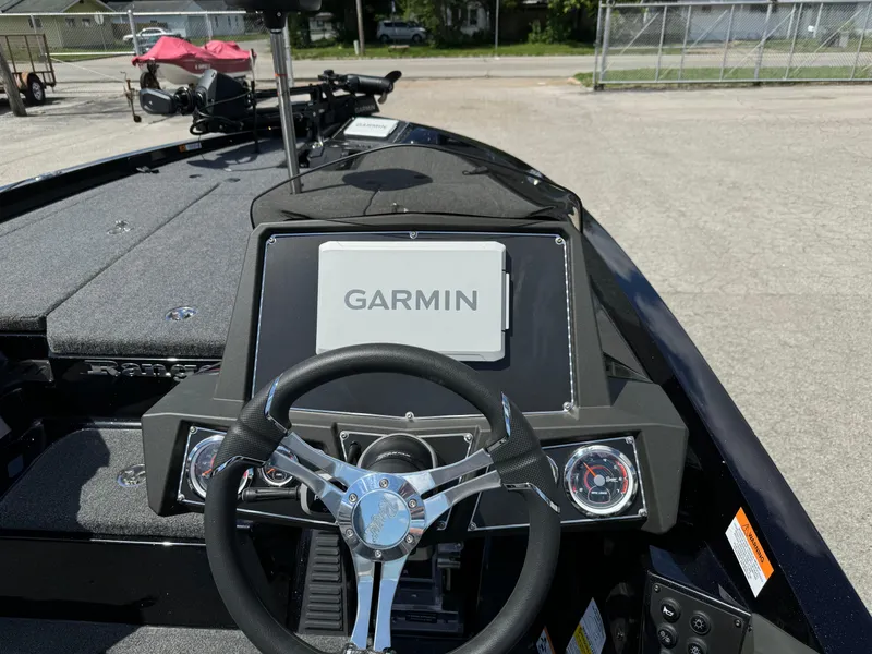 Slide: The Image of 2024 Ranger Z519 boat dashboard with Garmin navigation system and steering wheel. - 13