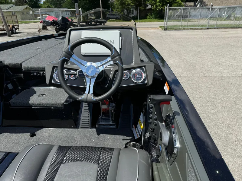Slide: The Image of 2024 Ranger Z519 Garmin Ranger Cup boat interior with steering wheel and dashboard controls. - 14