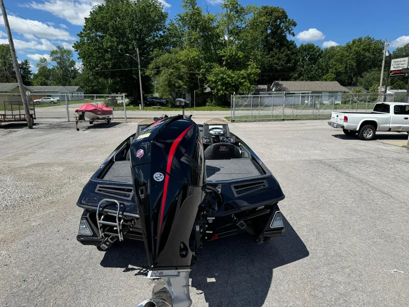 Slide: The Image of 2024 Ranger Z519 Garmin Ranger Cup boat with powerful outboard motor in a parking lot. - 2