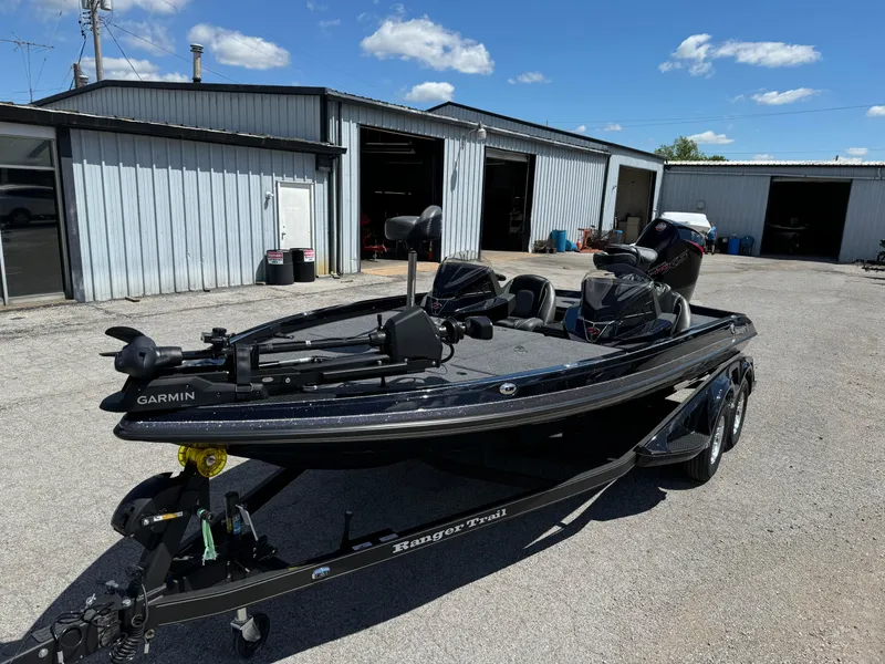 Slide: The Image of 2024 Ranger Z519 Garmin Ranger Cup Equipped boat parked outside a garage under a clear sky. - 7