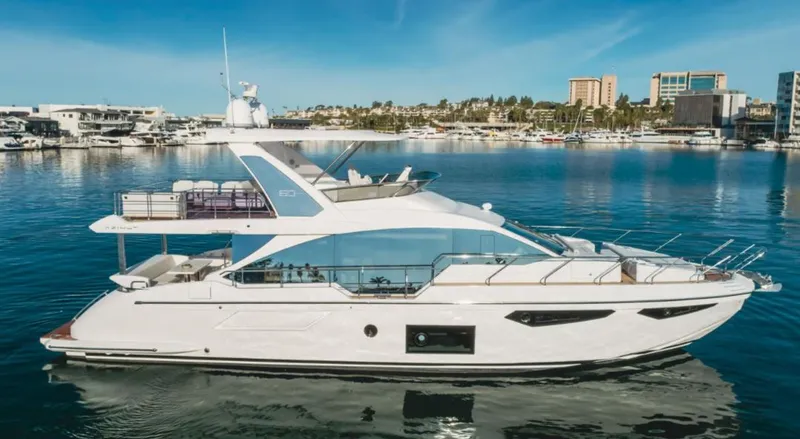Slide: The Image of 2024 Azimut Fly 60 yacht in a marina, showcasing sleek design and luxury features. - 0