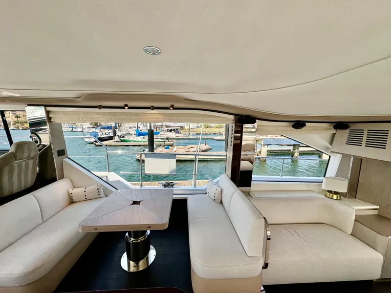 Slide: The Image of Luxurious interior of 2024 Azimut Fly 60 yacht with elegant seating and marina view. - 10