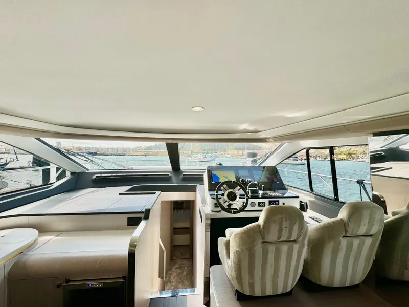 Slide: The Image of Interior of 2024 Azimut Fly 60 yacht, featuring modern helm and luxurious seating. - 11