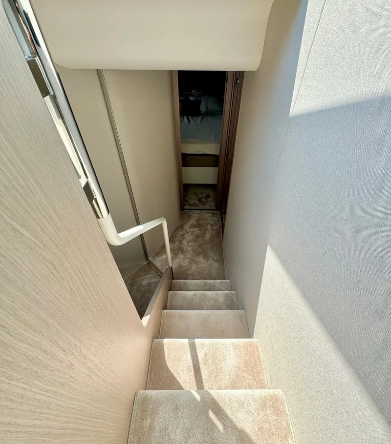 Slide: The Image of 2024 Azimut Fly 60 yacht interior staircase with modern design and carpeted steps. - 16