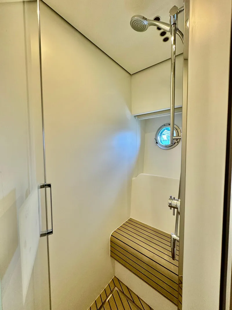 Slide: The Image of 2024 Azimut Fly 60 yacht shower with wooden bench and modern fixtures. - 18