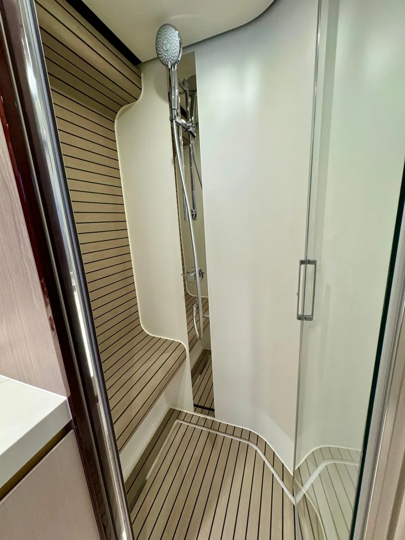 Slide: The Image of Luxurious shower area in 2024 Azimut Fly 60 yacht with sleek design and wood accents. - 26