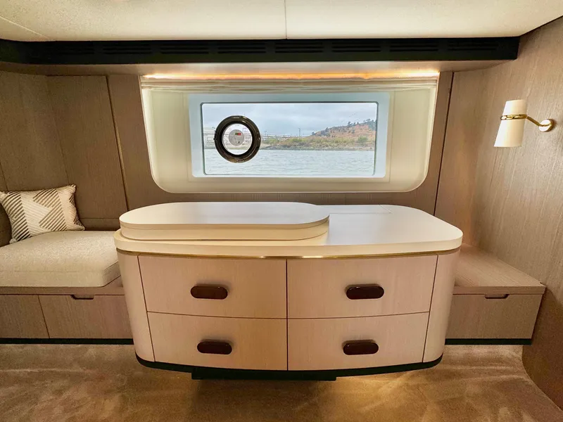 Slide: The Image of Luxurious interior of 2024 Azimut Fly 60 yacht with elegant wood cabinetry and scenic window view. - 29