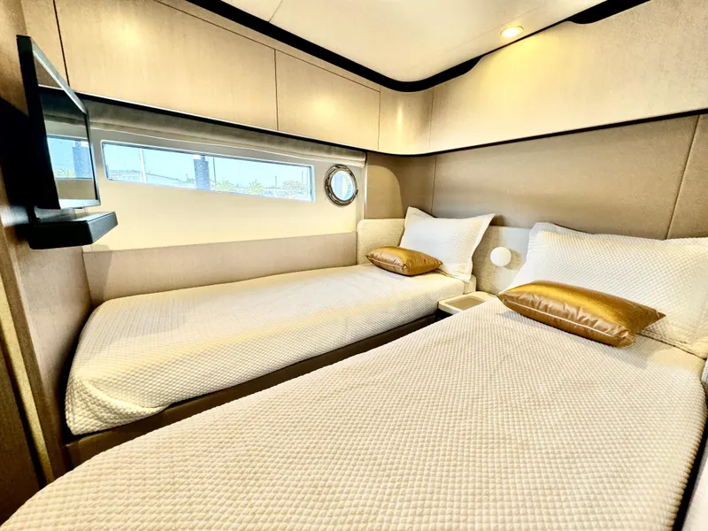 Slide: The Image of Luxurious twin cabin in 2024 Azimut Fly 60 yacht with modern decor and window view. - 32