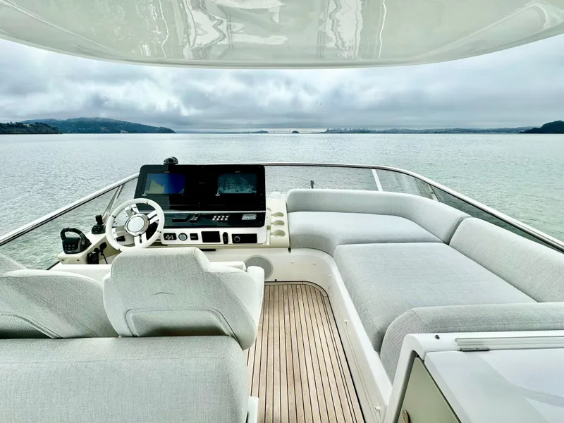 Slide: The Image of 2024 Azimut Fly 60 yacht interior with modern helm and spacious seating on calm waters. - 36