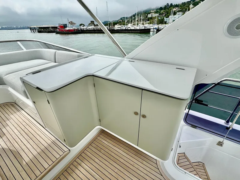 Slide: The Image of 2024 Azimut Fly 60 yacht deck with sleek cabinetry and waterfront view. - 40