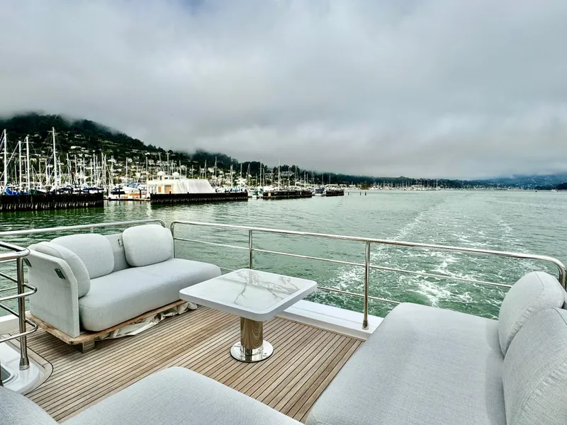 Slide: The Image of Luxurious 2024 Azimut Fly 60 yacht with elegant seating, scenic marina view. - 43
