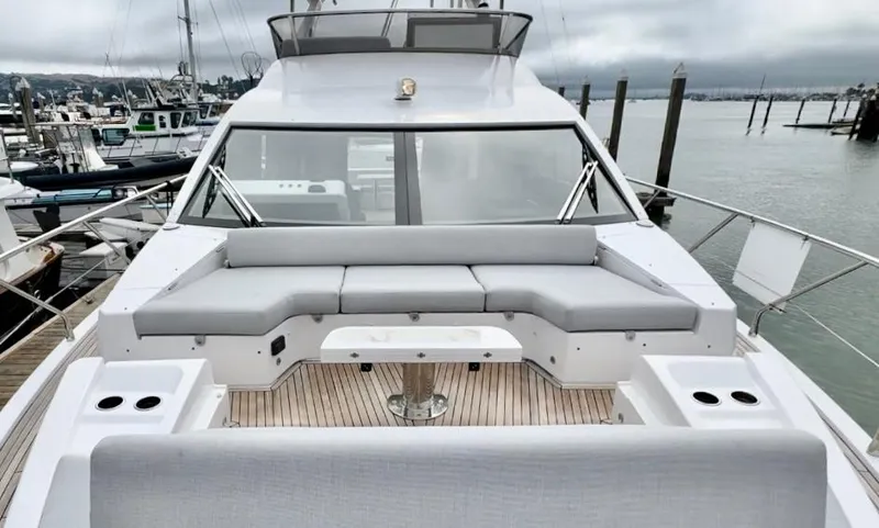 Slide: The Image of 2024 Azimut Fly 60 yacht with spacious deck seating at a marina. - 45