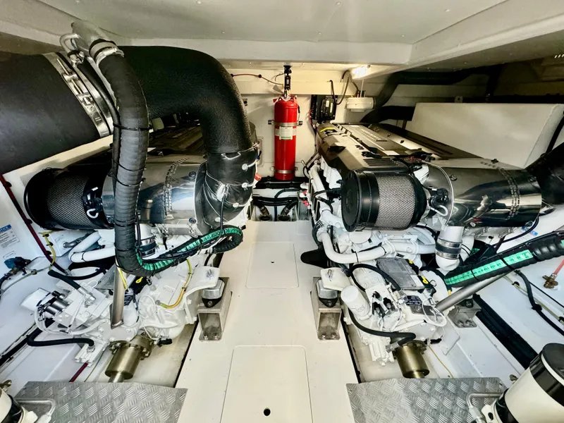 Slide: The Image of Engine room of 2024 Azimut Fly 60 yacht, featuring dual engines and fire extinguisher. - 49