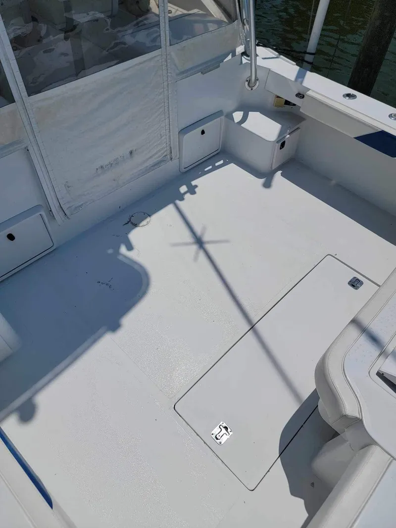 Slide: The Image of 1997 Luhrs 32 Open boat deck with storage compartments and seating area. - 14