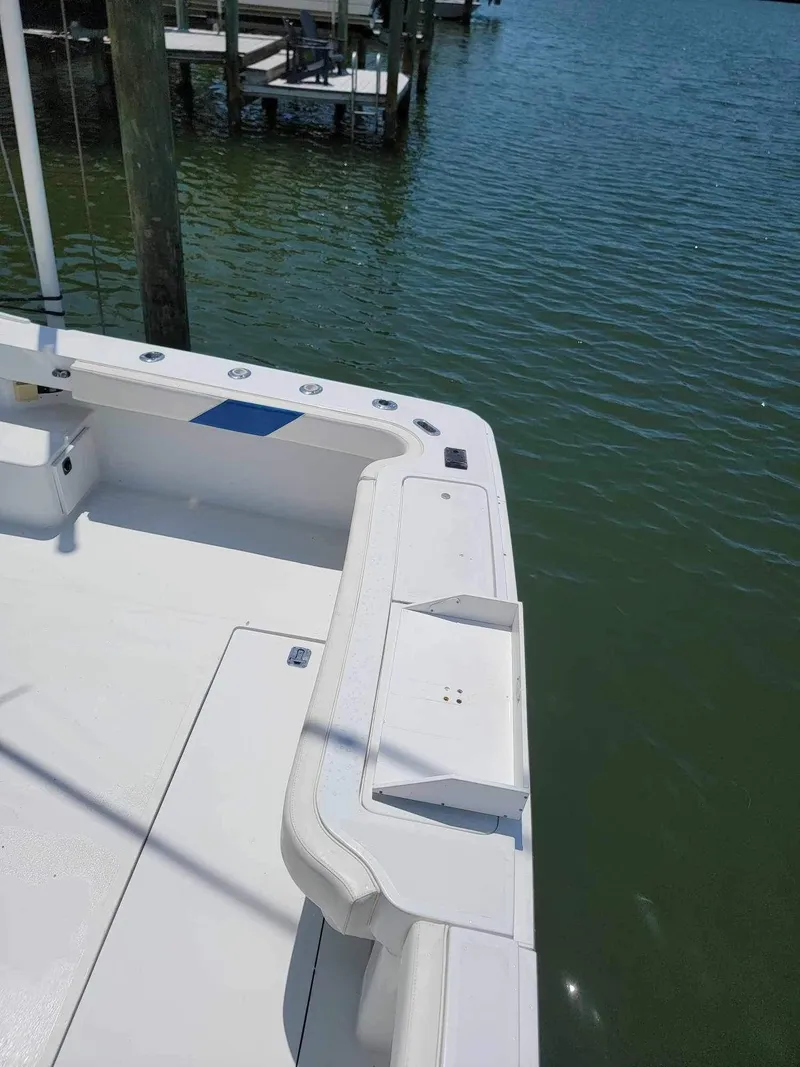 Slide: The Image of 1997 Luhrs 32 Open boat deck by the water, showcasing fishing rod holders. - 15