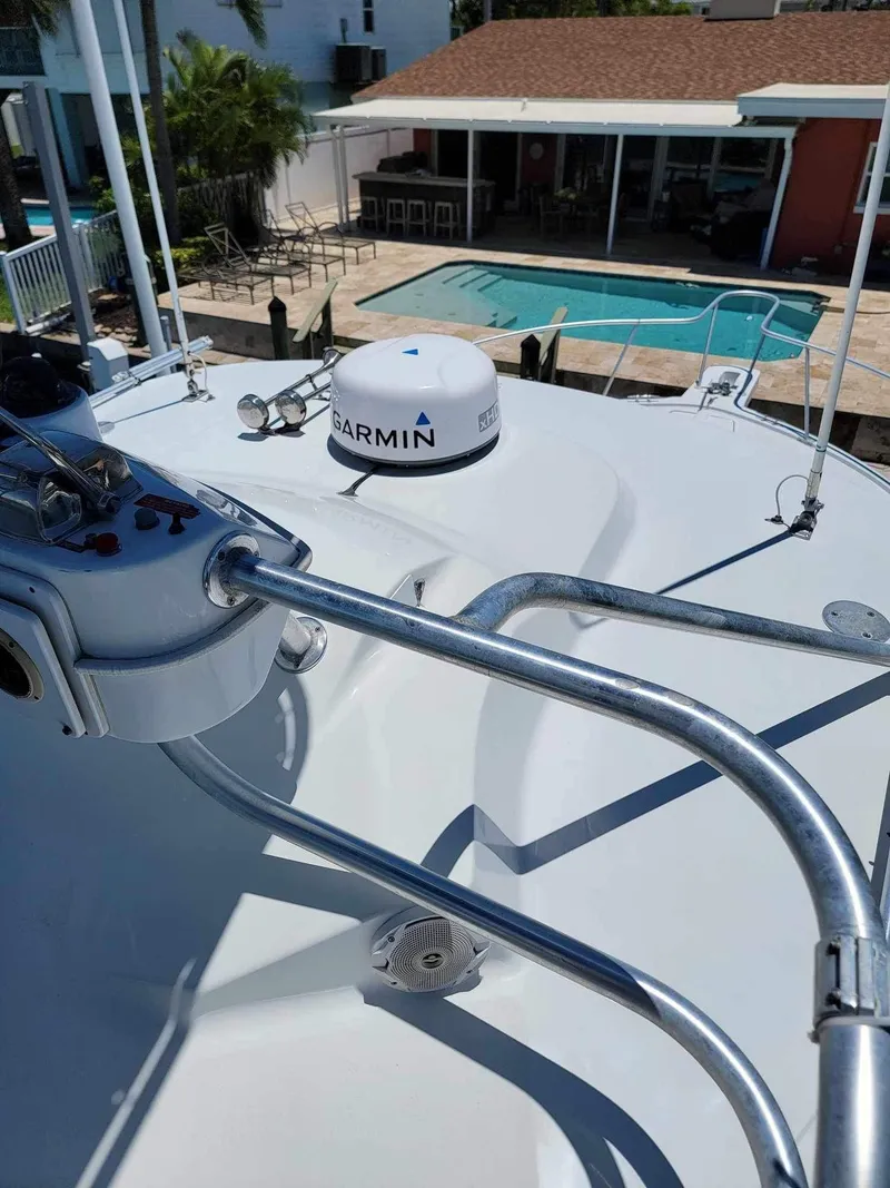 Slide: The Image of 1997 Luhrs 32 Open boat deck with Garmin equipment, overlooking a poolside view. - 27