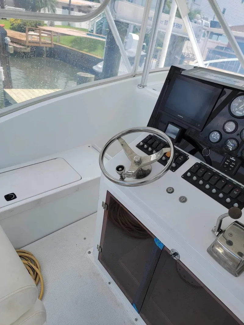 Slide: The Image of 1997 Luhrs 32 Open boat helm with steering wheel and control panel. - 28