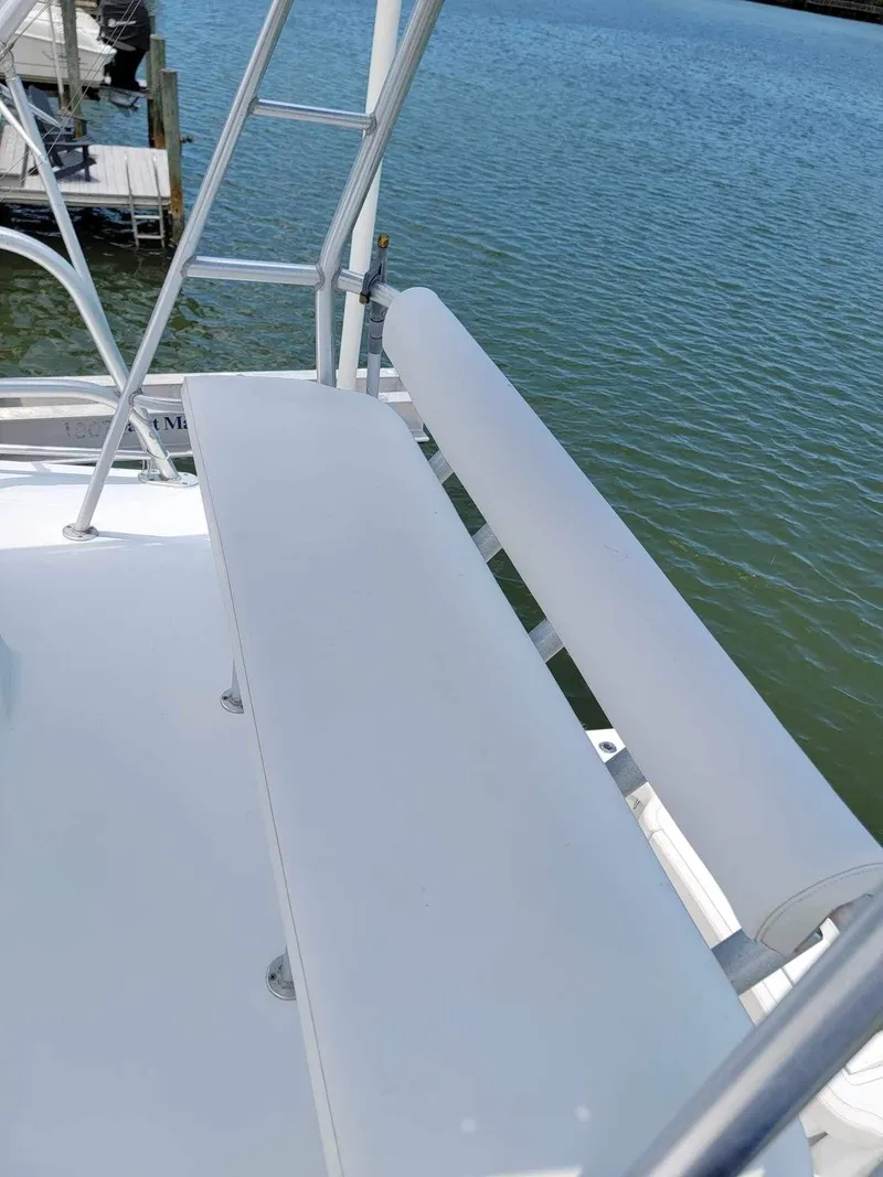 Slide: The Image of 1997 Luhrs 32 Open boat deck with seating and ladder by the water. - 29