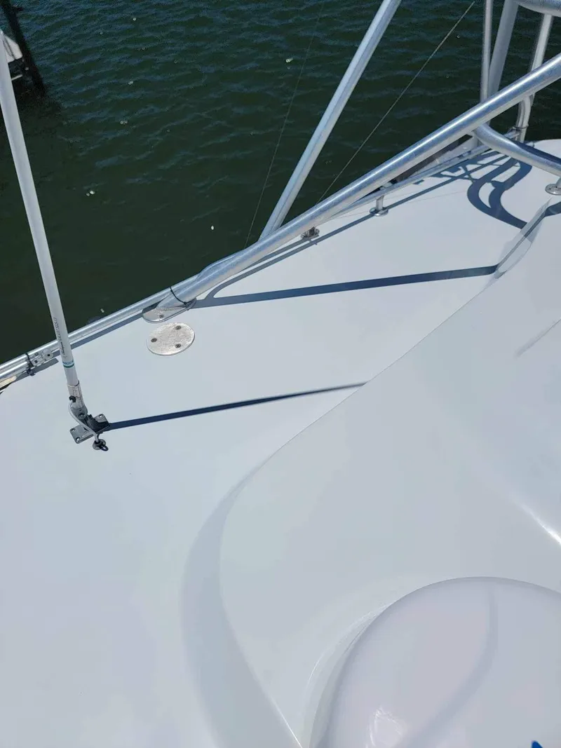Slide: The Image of 1997 Luhrs 32 Open boat deck with railing, overlooking water. - 33