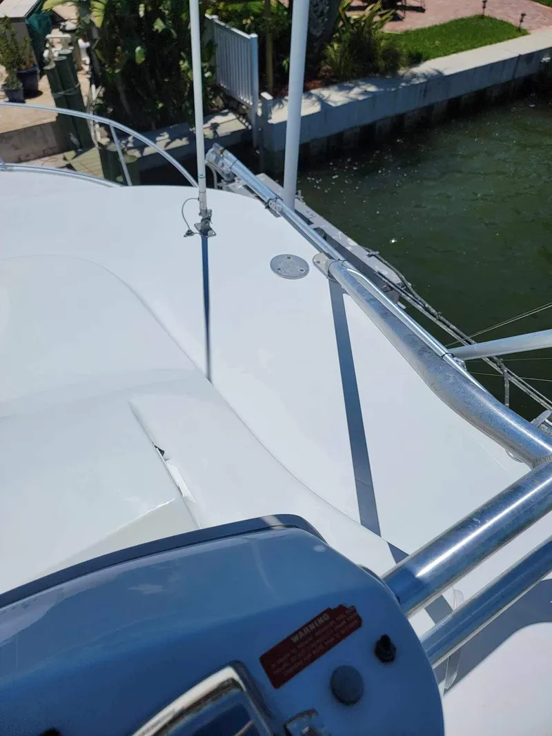 Slide: The Image of 1997 Luhrs 32 Open boat deck with railing, docked by the water. - 34