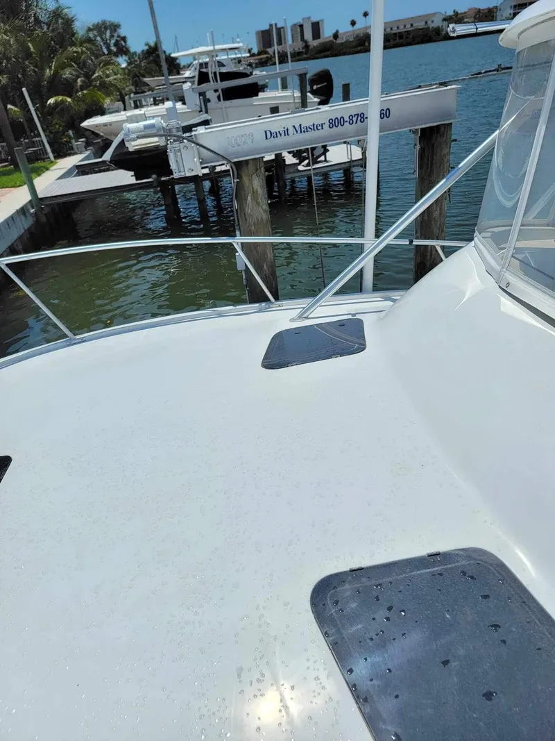 Slide: The Image of 1997 Luhrs 32 Open boat deck with marina view in the background. - 36