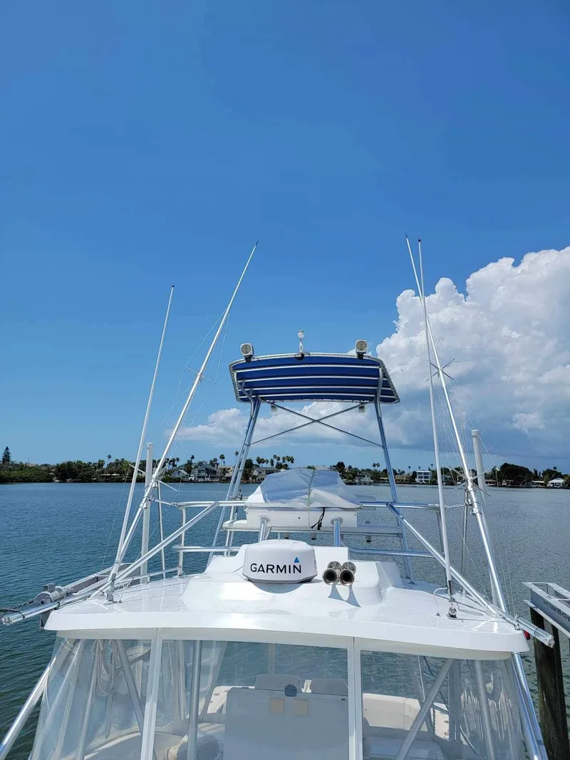 Slide: The Image of 1997 Luhrs 32 Open boat with Garmin equipment on a sunny day by the water. - 39
