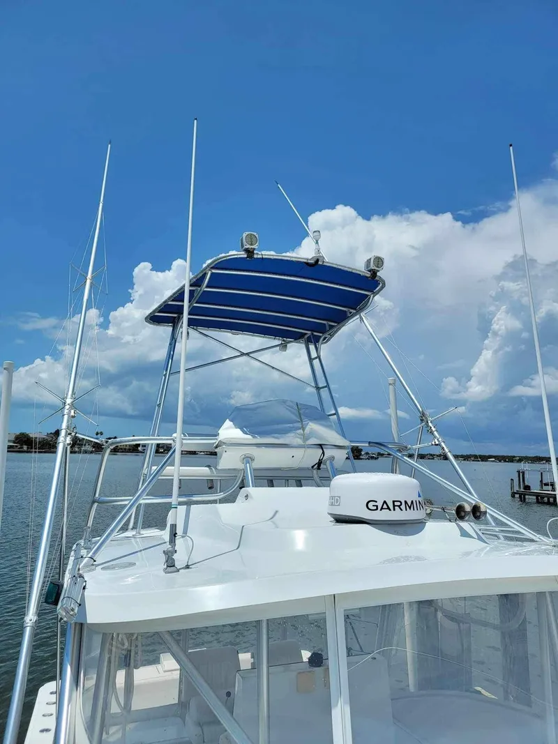 Slide: The Image of 1997 Luhrs 32 Open boat with blue canopy and Garmin radar on a sunny day. - 41