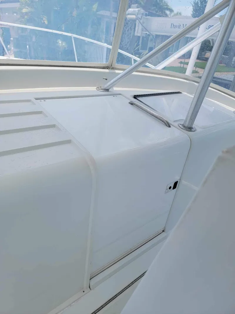 Slide: The Image of 1997 Luhrs 32 Open boat deck with railing and storage compartment. - 47