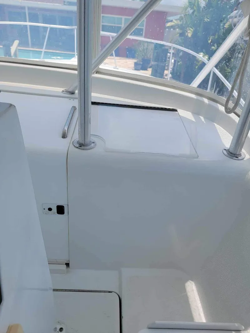 Slide: The Image of 1997 Luhrs 32 Open boat interior with white surfaces and metal railings. - 48