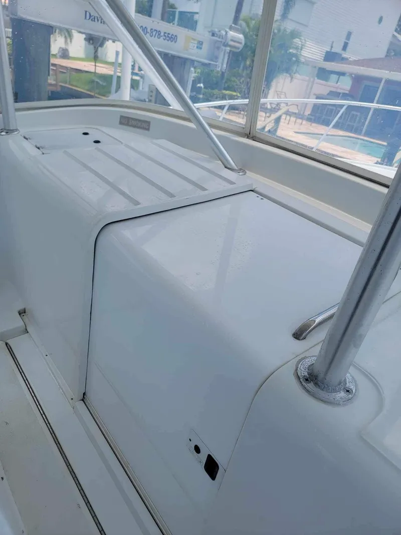 Slide: The Image of 1997 Luhrs 32 Open boat interior with white seating and metal railings. - 49