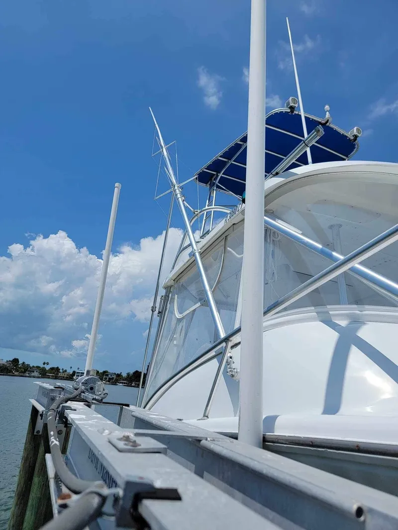 Slide: The Image of 1997 Luhrs 32 Open boat docked under a clear blue sky. - 6