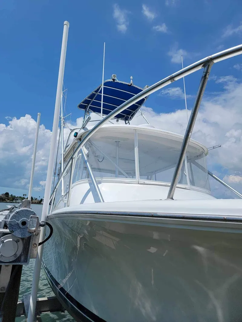 Slide: The Image of 1997 Luhrs 32 Open boat docked under a clear blue sky. - 7