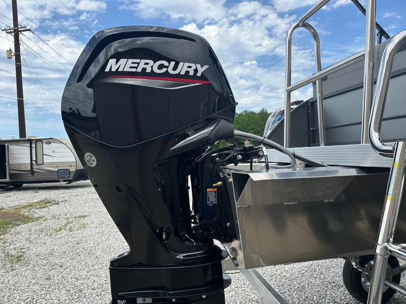 Slide: The Image of 2024 Massimo Marine P-21R with Mercury outboard motor in a gravel lot. - 2