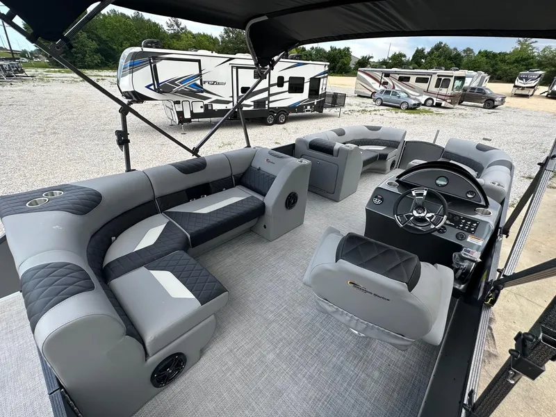 Slide: The Image of 2024 Massimo Marine P-21R pontoon boat interior with luxurious seating and modern dashboard. - 6