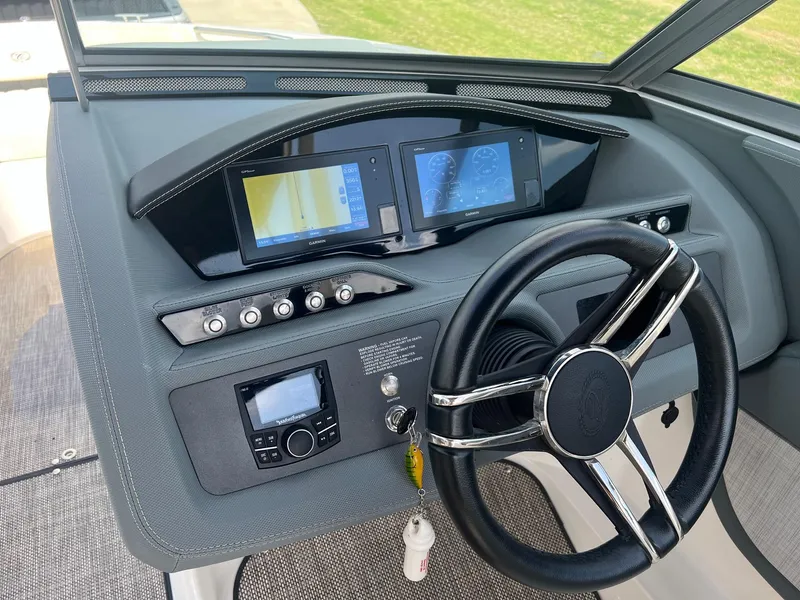 Slide: The Image of 2019 Cobalt R3 boat dashboard with dual screens and steering wheel. - 11