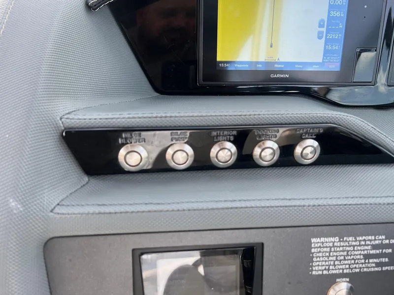 Slide: The Image of Control panel of a 2019 Cobalt R3 boat with various switches and a Garmin display. - 13