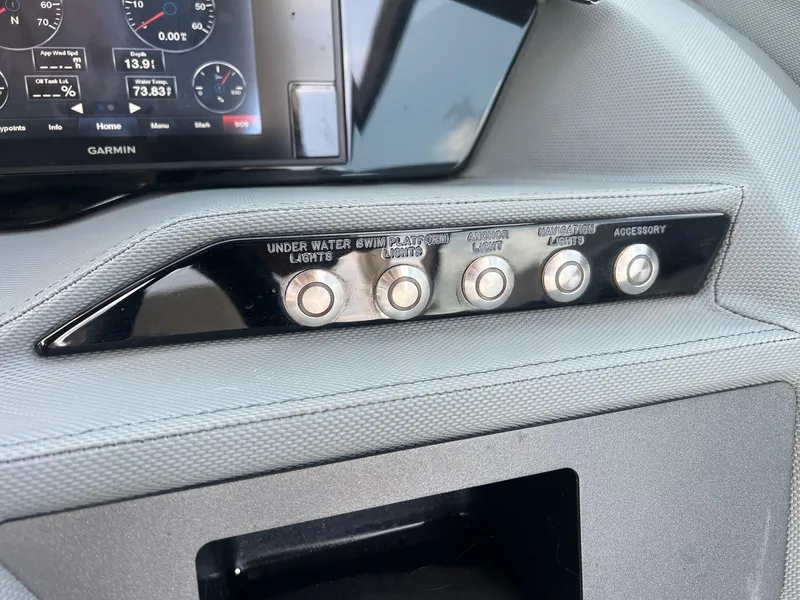 Slide: The Image of 2019 Cobalt R3 boat dashboard with control buttons and Garmin display. - 14