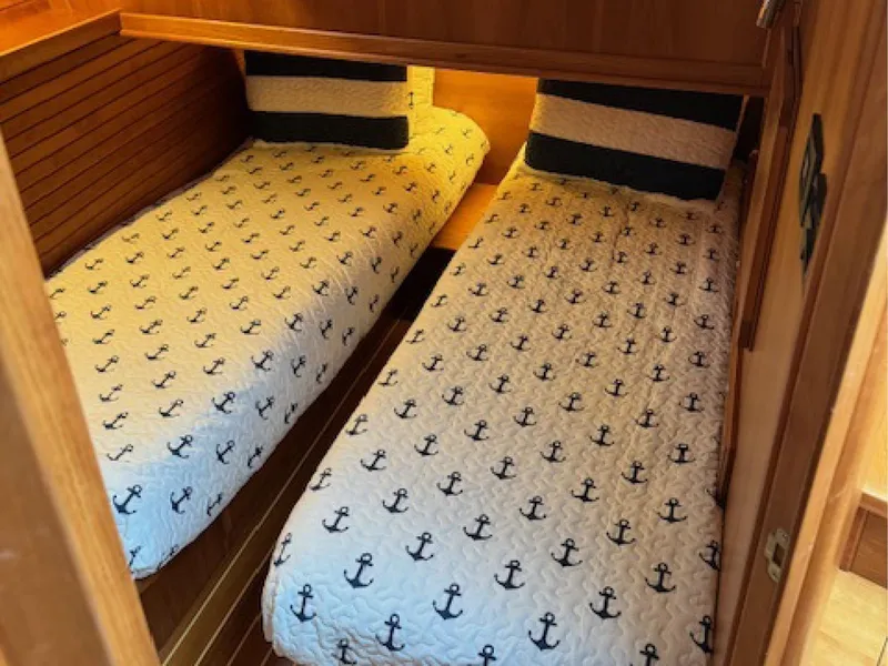 Slide: The Image of Twin beds with anchor-patterned bedding in 2017 Sabre 45 Salon Express cabin. - 10