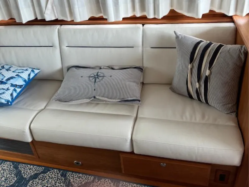 Slide: The Image of White leather seating with decorative pillows on a 2017 Sabre 45 Salon Express yacht. - 6