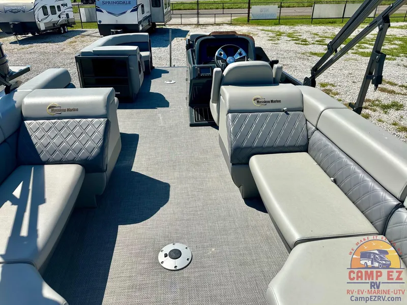 Slide: The Image of 2024 Massimo Marine P24-LTD QUAD pontoon boat interior with luxurious seating and steering console. - 15