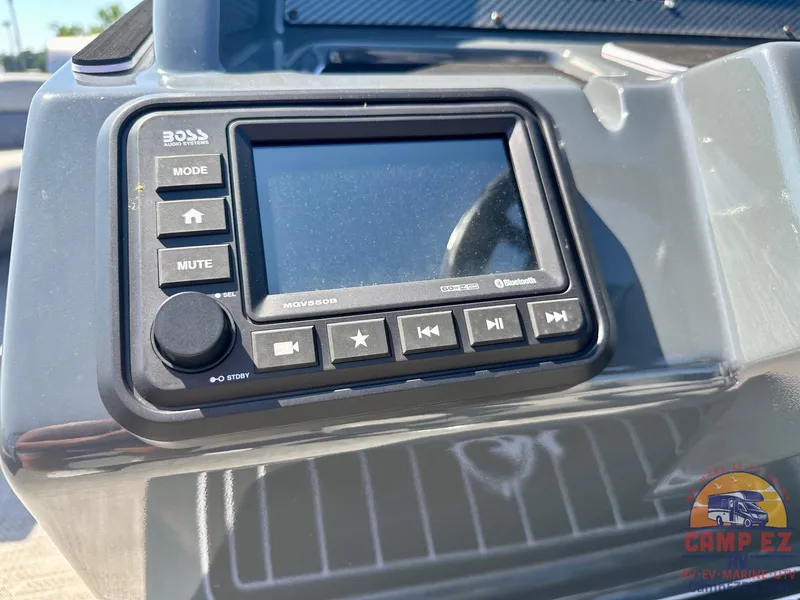 Slide: The Image of 2024 Massimo Marine P24-LTD QUAD boat dashboard with Boss audio system. - 3