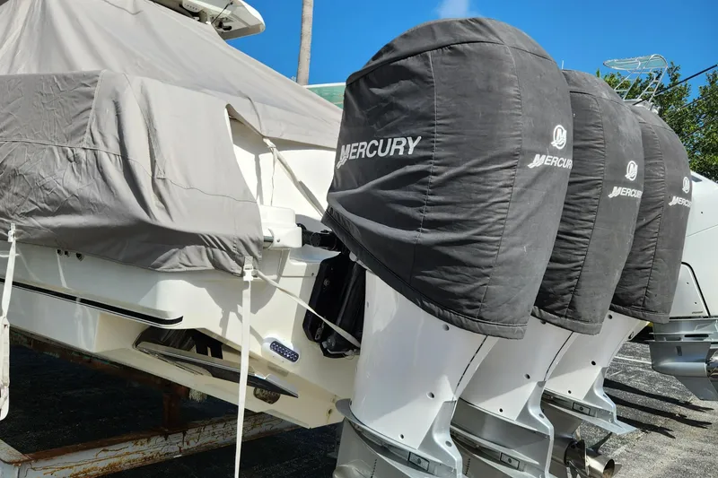 Slide: The Image of 2014 Boston Whaler 350 Outrage with covered Mercury outboard engines. - 10
