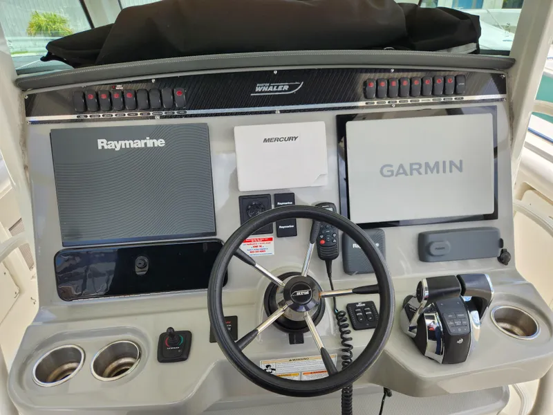Slide: The Image of 2014 Boston Whaler 350 Outrage helm with Raymarine and Garmin navigation systems. - 15