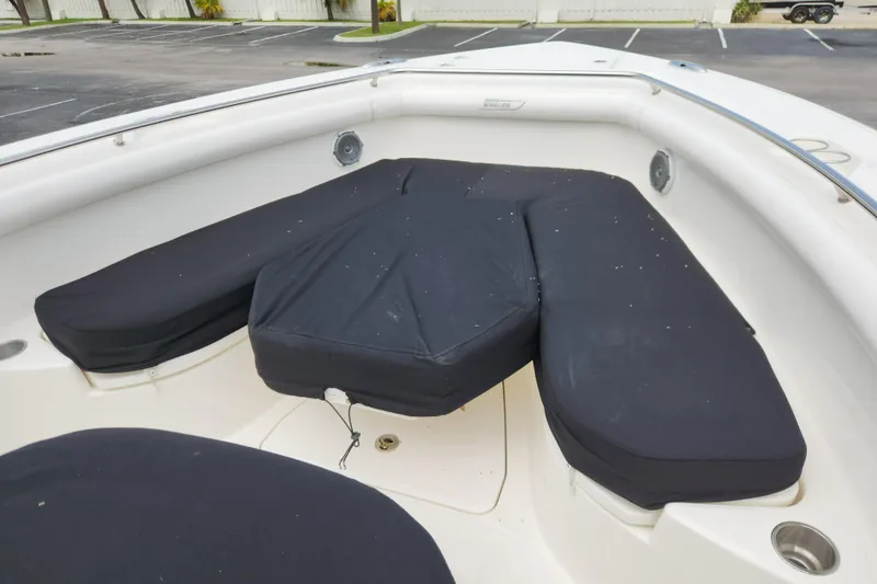 Slide: The Image of 2014 Boston Whaler 350 Outrage bow seating area with black cushions. - 17