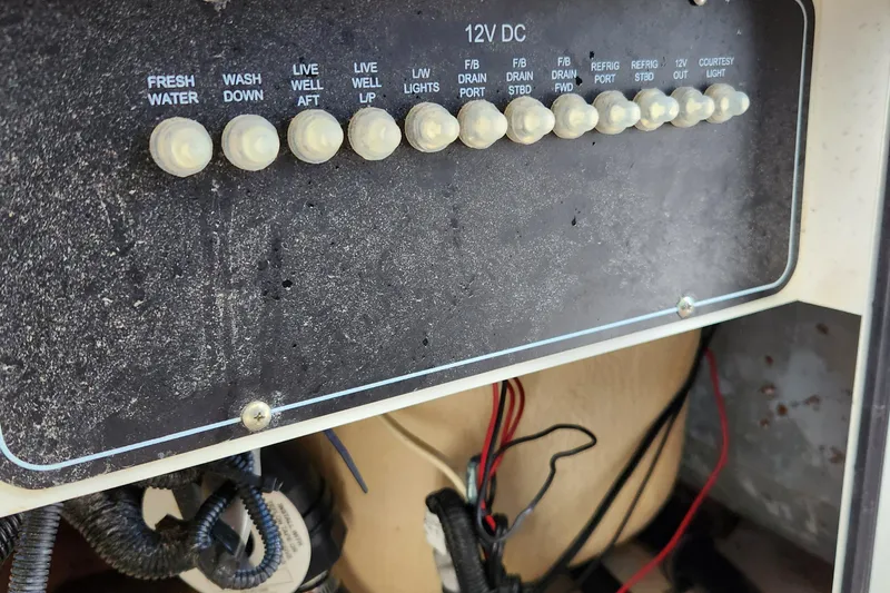 Slide: The Image of Control panel of a 2014 Boston Whaler 350 Outrage boat with various switches. - 45
