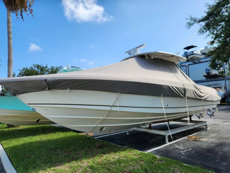Slide: The Image of 2014 Boston Whaler 350 Outrage boat covered and parked on a trailer. - 6