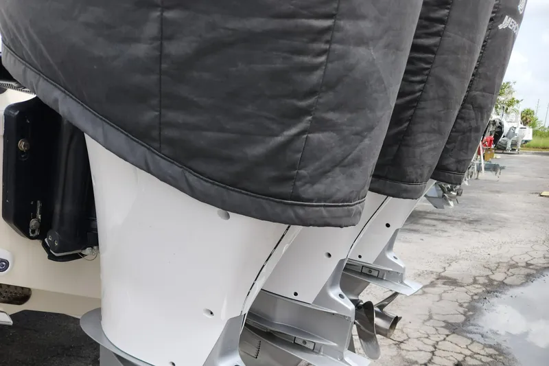 Slide: The Image of Close-up of 2014 Boston Whaler 350 Outrage outboard motors in a parking lot. - 8