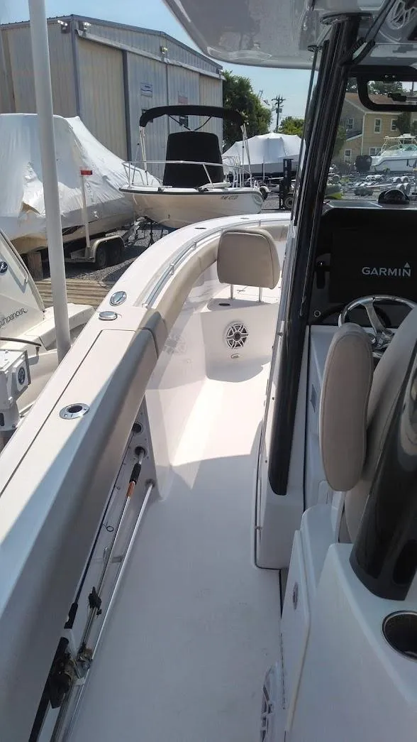 Slide: The Image of 2022 Sportsman Open 302 Center Console boat interior, docked at a marina. - 12